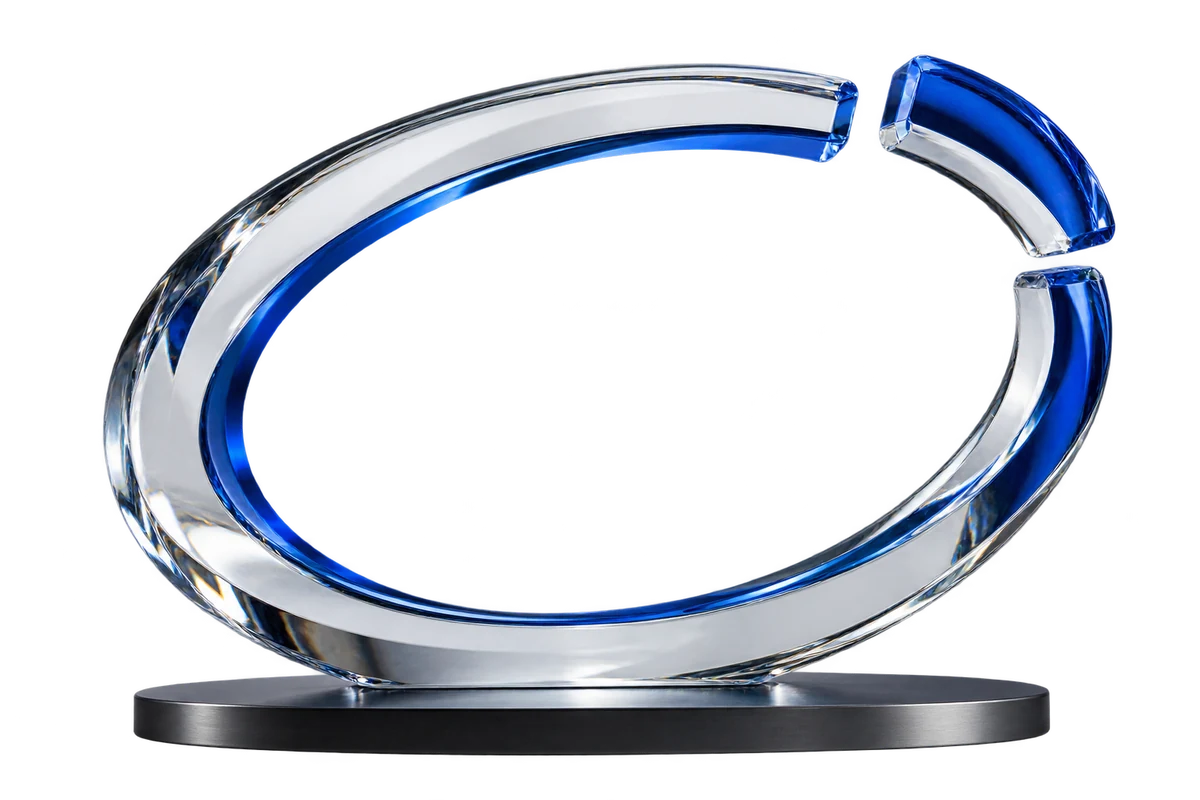 Optical glass loop with a separated cobalt-blue segment on a graphite base.